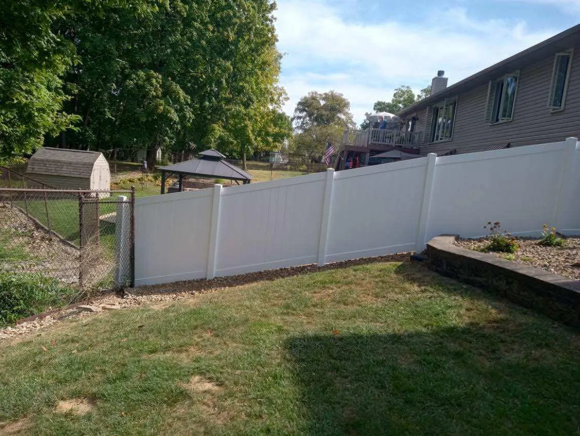 White vinyl privacy fence installed along a backyard in Peoria, Illinois